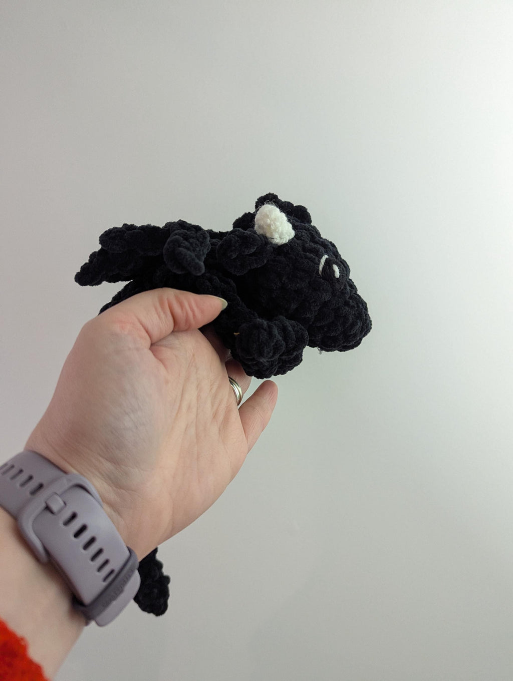 Plush crocheted dragon lovey, soft cuddly toy