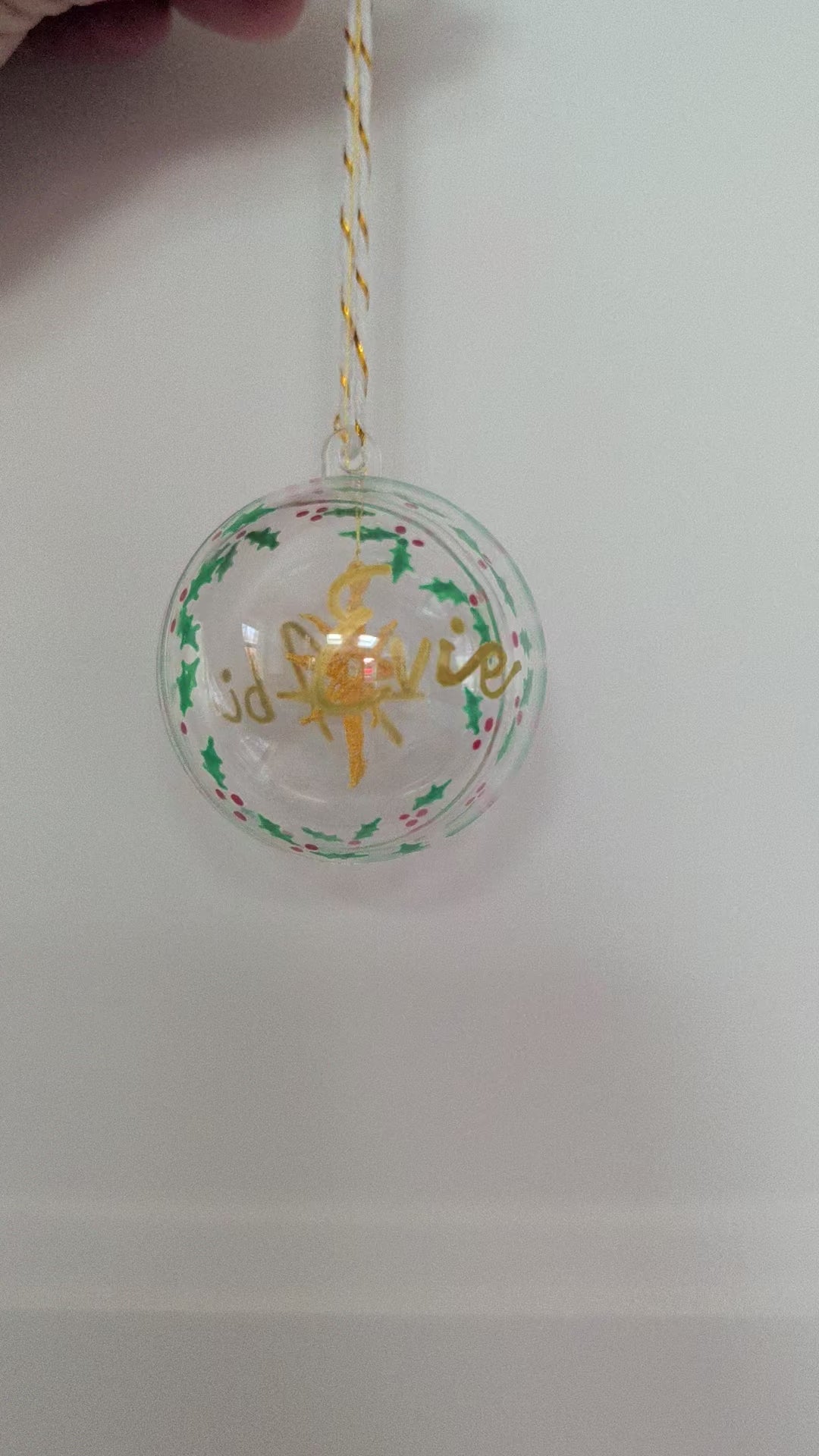 Personalised hand painted name bauble with embroidered star suspended in centre