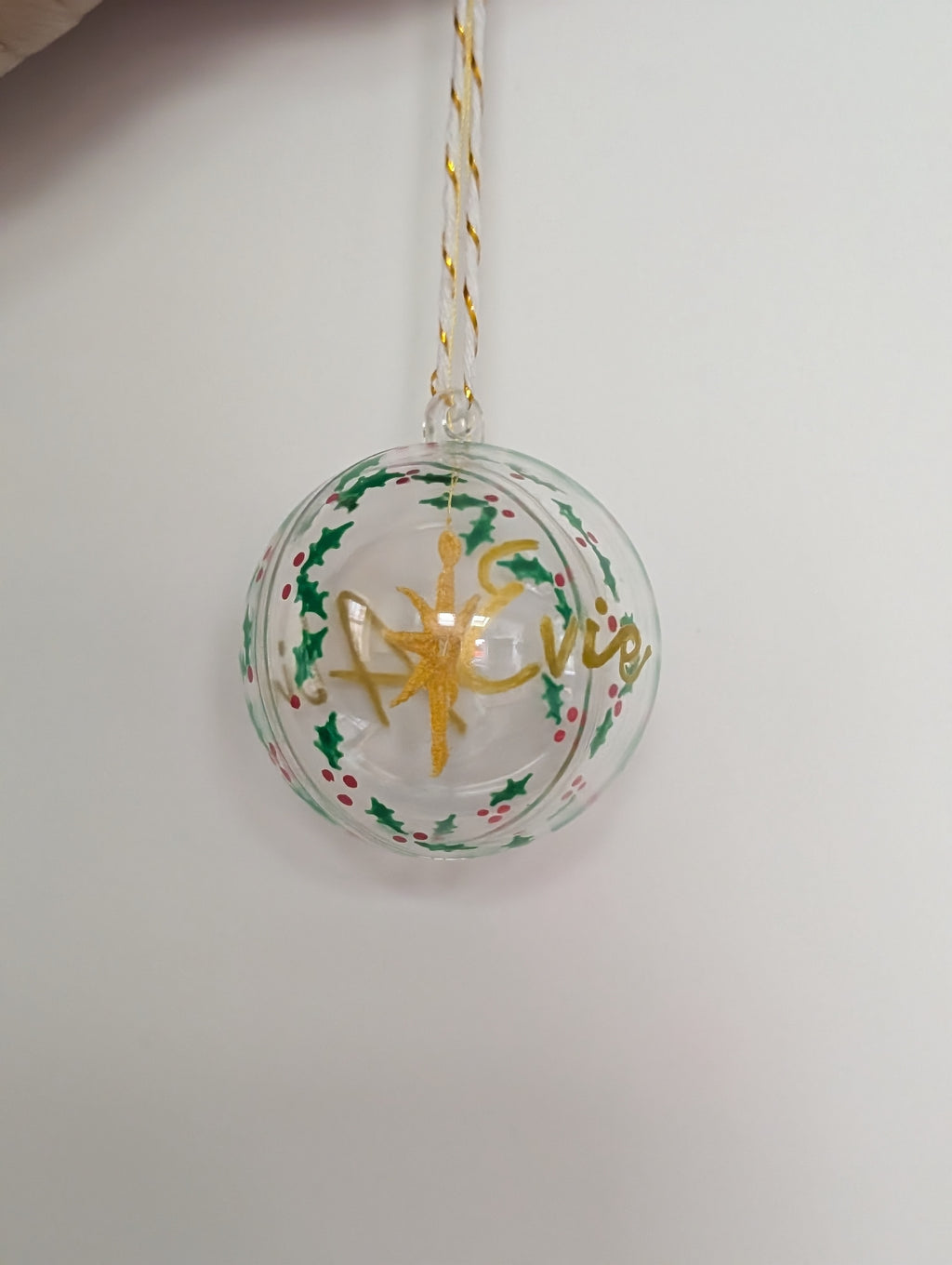 Personalised hand painted name bauble with embroidered star suspended in centre