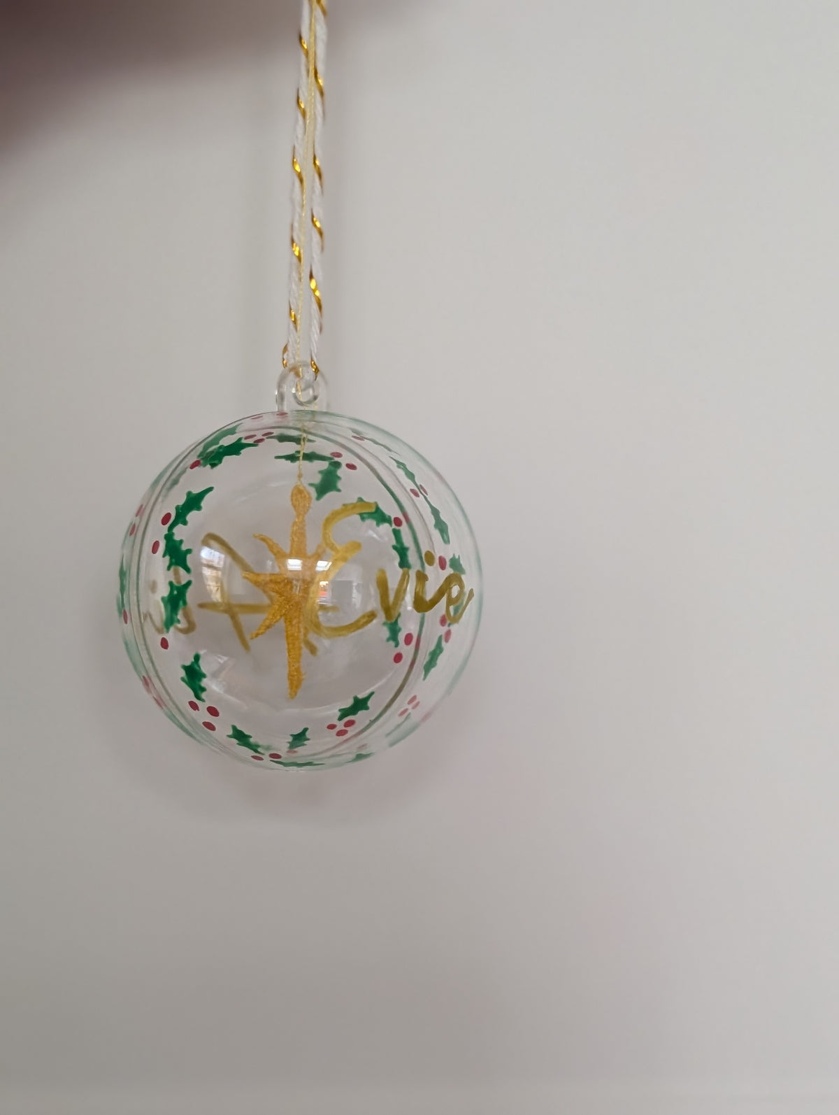 Personalised hand painted name bauble with embroidered star suspended in centre